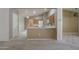 Open kitchen area with white countertops and wood cabinets at 8660 E Nido Ave, Mesa, AZ 85209