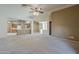 Spacious, open-concept living area with carpet flooring at 8660 E Nido Ave, Mesa, AZ 85209