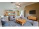 Cozy living room with neutral tones, ceiling fan, and an open layout to the kitchen at 8660 E Nido Ave, Mesa, AZ 85209