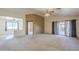 Bright living area showcasing an open layout, carpet flooring, and a sliding glass door at 8660 E Nido Ave, Mesa, AZ 85209