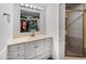 Well-lit bathroom featuring a sink vanity with ample storage and shower with gold frame at 9431 E Coralbell Ave # 192, Mesa, AZ 85208