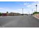 Community entrance with well-maintained roads and lush palm trees under a clear blue sky at 9431 E Coralbell Ave # 192, Mesa, AZ 85208
