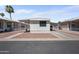 Exterior view of a single-story home with a carport, gravel landscaping, and covered entry at 9431 E Coralbell Ave # 192, Mesa, AZ 85208