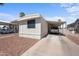 Exterior view of a mobile home with a carport and gravel landscaping at 9431 E Coralbell Ave # 192, Mesa, AZ 85208