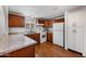 Charming kitchen featuring brown wooden cabinets, granite countertops, and essential modern white appliances at 9431 E Coralbell Ave # 192, Mesa, AZ 85208