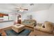 Comfortable living room featuring neutral sofas, a ceiling fan, and an open view to the kitchen at 9431 E Coralbell Ave # 192, Mesa, AZ 85208