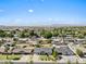 Aerial view of the homes in the neighborhood with lush trees and Mountain views at 1050 W 9Th Pl, Mesa, AZ 85201