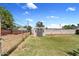 Home's backyard featuring a well-maintained lawn, brick perimeter wall, and exterior storage building at 1050 W 9Th Pl, Mesa, AZ 85201