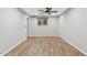 Spacious bedroom featuring wood-look floors, a ceiling fan, and a window for natural light at 1050 W 9Th Pl, Mesa, AZ 85201