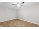 This bedroom features wood-look floors, a ceiling fan, and neutral walls at 1050 W 9Th Pl, Mesa, AZ 85201