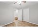 Bedroom with wood floors, ceiling fan, and an open doorway to a stairway at 1050 W 9Th Pl, Mesa, AZ 85201