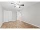 Light and airy bedroom featuring wood floors, ceiling fan, and closet for storage at 1050 W 9Th Pl, Mesa, AZ 85201