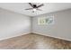 This bedroom features wood-look floors, a ceiling fan, and a window for natural light at 1050 W 9Th Pl, Mesa, AZ 85201