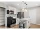 Updated kitchen featuring white cabinets, a center island, and stainless steel appliances at 1050 W 9Th Pl, Mesa, AZ 85201