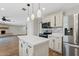 Kitchen with stainless steel appliances, a kitchen island, and an open floor plan at 1050 W 9Th Pl, Mesa, AZ 85201