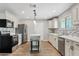 Updated kitchen boasts stainless steel appliances, quartz countertops, and a breakfast bar at 1050 W 9Th Pl, Mesa, AZ 85201