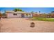 A spacious backyard featuring a fire pit area, a covered patio and a well-maintained lawn at 1058 E 2Nd St, Mesa, AZ 85203