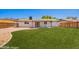 Expansive backyard featuring green grass and the rear facade of the house at 1058 E 2Nd St, Mesa, AZ 85203