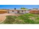 A backyard features a well-maintained lawn, a covered patio and a perimeter wooden fence at 1058 E 2Nd St, Mesa, AZ 85203