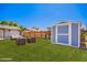 Serene backyard featuring a shed, outdoor seating, and lush green grass at 1058 E 2Nd St, Mesa, AZ 85203