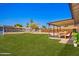 Lush backyard with an outdoor dining set, shed, and mature trees at 1058 E 2Nd St, Mesa, AZ 85203