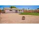 Wide view of the backyard, featuring a gravel area, green lawn and back of the house at 1058 E 2Nd St, Mesa, AZ 85203