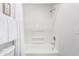 Clean, all-white tiled bathroom features a shower and tub combination at 1058 E 2Nd St, Mesa, AZ 85203