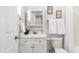 Bright bathroom with a white vanity, floral decor, and a well-lit mirror at 1058 E 2Nd St, Mesa, AZ 85203