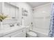 Clean bathroom with white vanity, shower-tub combination, and decorative accents at 1058 E 2Nd St, Mesa, AZ 85203