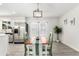 Open dining area featuring a stylish light fixture and french doors at 1058 E 2Nd St, Mesa, AZ 85203