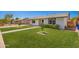 Well-maintained single-story home with a lush green lawn and charming brick pathway leading to the entrance at 1058 E 2Nd St, Mesa, AZ 85203