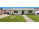 Charming single-story home boasts a manicured lawn and inviting brick pathway to the front door at 1058 E 2Nd St, Mesa, AZ 85203