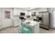 Kitchen with stainless appliances, white cabinets, and breakfast bar seating at 1058 E 2Nd St, Mesa, AZ 85203