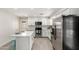 Bright kitchen with white cabinets, stainless appliances, and island seating at 1058 E 2Nd St, Mesa, AZ 85203