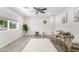 Bright living room features modern flooring, neutral walls, a ceiling fan, and large window at 1058 E 2Nd St, Mesa, AZ 85203