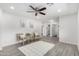 Bright living room features modern flooring, neutral walls, a ceiling fan, and views to the bathroom at 1058 E 2Nd St, Mesa, AZ 85203