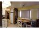 Cozy dining area adjacent to the kitchen, features a table set for a meal, and built in display cabinet at 111 S Greenfield -- # 602, Mesa, AZ 85206
