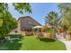 Spacious backyard features a vibrant lawn, lush landscaping, a charming seating area, and a private swimming pool at 1149 N Sunnyvale Ave, Gilbert, AZ 85234