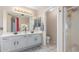 Bright bathroom with double vanity, large mirrors, and walk-in shower with access to the lavatory at 1149 N Sunnyvale Ave, Gilbert, AZ 85234