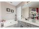 Bathroom featuring a soaking tub, vanity with sink, and window providing natural light at 1149 N Sunnyvale Ave, Gilbert, AZ 85234