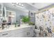 Bathroom with white vanity, decorated mirror, and plant accents that enhance its appeal at 1149 N Sunnyvale Ave, Gilbert, AZ 85234