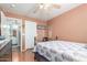 Bedroom featuring a ceiling fan, door, and access to an adjoining bathroom with a vanity at 1149 N Sunnyvale Ave, Gilbert, AZ 85234