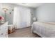 Bedroom with a dresser, fan, and a window for natural light, offering a serene and calm space at 1149 N Sunnyvale Ave, Gilbert, AZ 85234