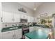 Well-lit kitchen showcasing white cabinets, dark countertops, stainless steel appliances, and a garden view at 1149 N Sunnyvale Ave, Gilbert, AZ 85234