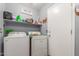 Functional laundry room features a washer, dryer, shelving, and ample storage space for organization at 1149 N Sunnyvale Ave, Gilbert, AZ 85234