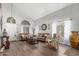 Bright living room with vaulted ceilings, wood floors, and ample natural light from large windows at 1149 N Sunnyvale Ave, Gilbert, AZ 85234