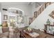 Bright living room with vaulted ceilings, wood floors, and staircase to the second floor at 1149 N Sunnyvale Ave, Gilbert, AZ 85234