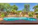 Stunning swimming pool surrounded by lush greenery and mature trees to create a private backyard oasis at 1149 N Sunnyvale Ave, Gilbert, AZ 85234