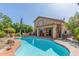 Inviting swimming pool features a custom shape, mature landscaping, and cozy patio area ideal for outdoor living at 1149 N Sunnyvale Ave, Gilbert, AZ 85234