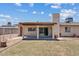 Backyard patio with covered area, sliding glass door and well maintained lawn at 1160 E Hampton Cir, Mesa, AZ 85204